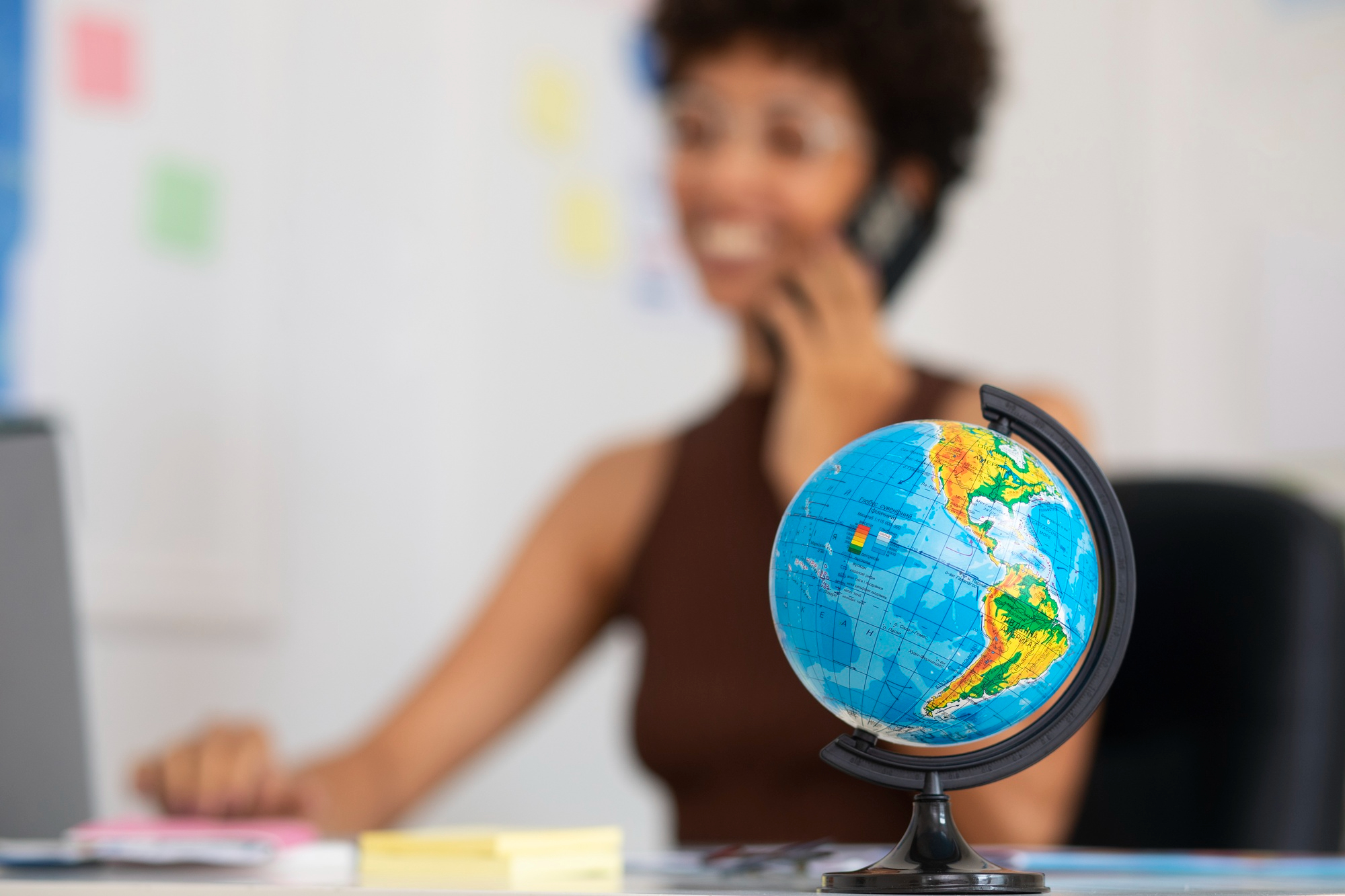 Globe with professional woman in background