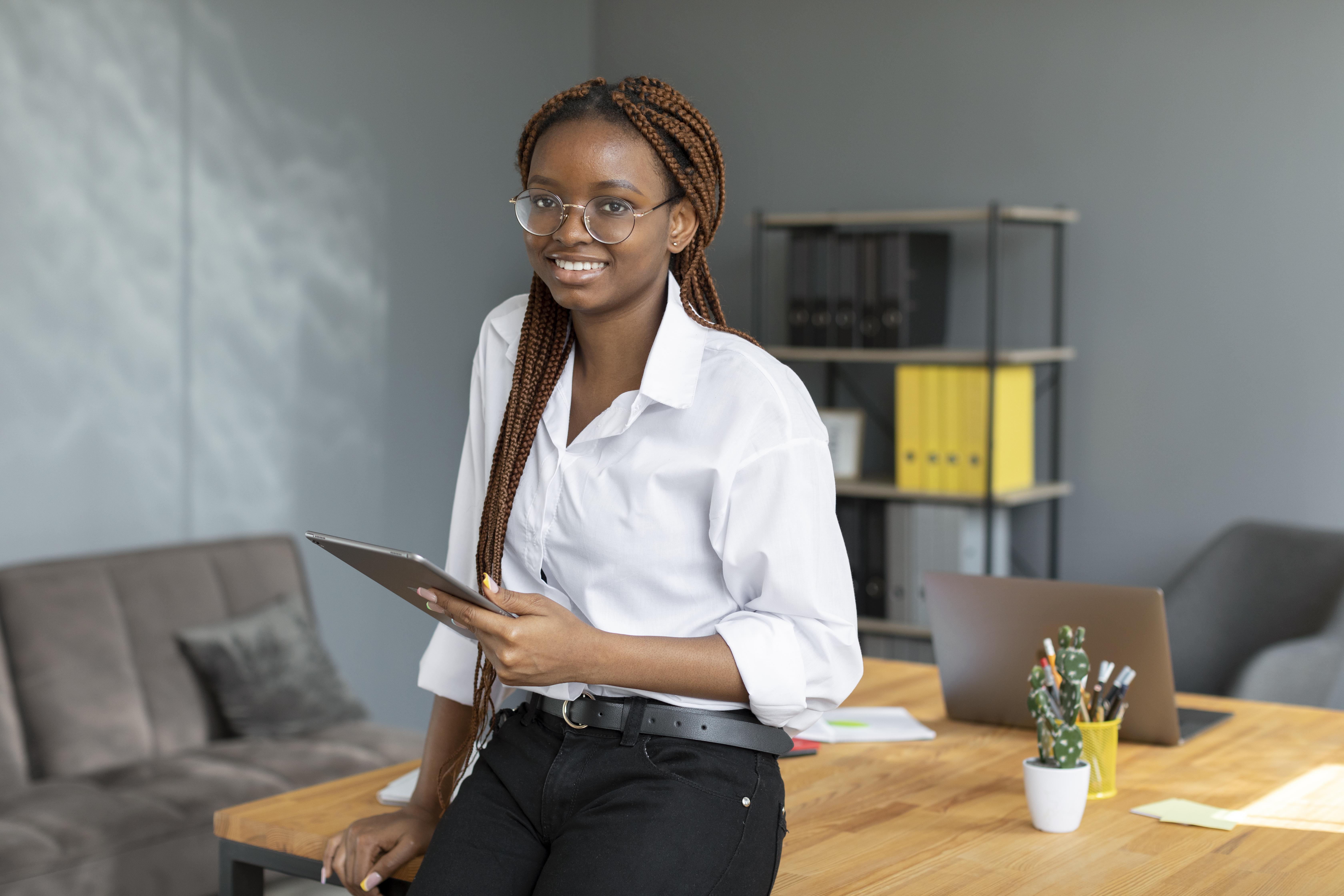 Professional woman with tablet in modern office